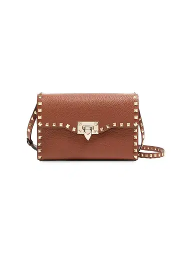 Valentino Garavani Women's Small Rockstud Grainy Calfskin Crossbody Bag - Saddle Brown | Thumbnail 1 Valentino Garavani Women's Small Rockstud Grainy Calfskin Crossbody Bag - Saddle Brown | Thumbnail 1