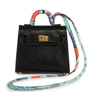 HERMÈS Hermes Mini Kelly Twilly Bag Charm Black Shiny Niloticus Lizard Gold Hardware | Thumbnail 1 HERMÈS Hermes Mini Kelly Twilly Bag Charm Black Shiny Niloticus Lizard Gold Hardware | Thumbnail 1