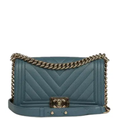 Chanel Pre-owned Chanel Medium Chevron Boy Bag Blue Caviar Light Gold Hardware | Thumbnail 1 Chanel Pre-owned Chanel Medium Chevron Boy Bag Blue Caviar Light Gold Hardware | Thumbnail 1