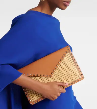 Valentino Garavani Rockstud Large leather-trimmed raffia clutch | Thumbnail 6