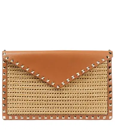 Valentino Garavani Rockstud Large leather-trimmed raffia clutch | Thumbnail 1