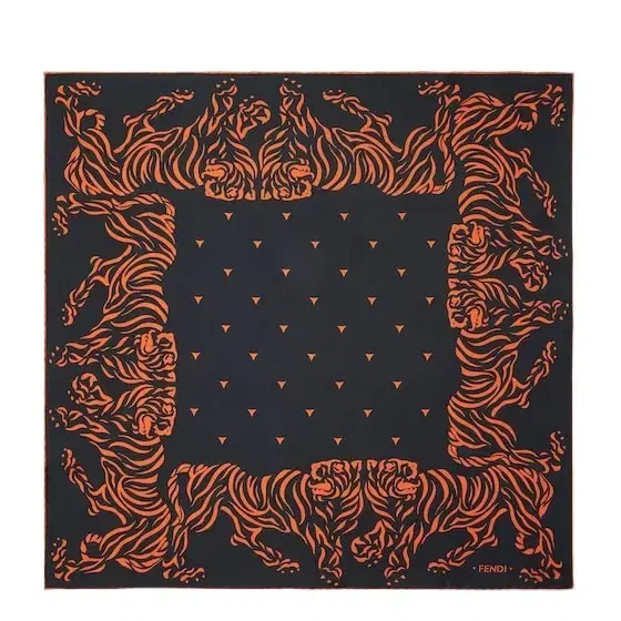 A square scarf featuring a stencil-effect print of