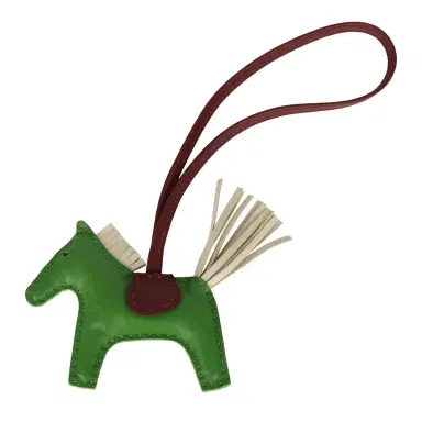 HERMÈS Hermes Rodeo Bag Charm PM Vert Yucca, Craie, Rouge H Milo Lambskin | Thumbnail 1 HERMÈS Hermes Rodeo Bag Charm PM Vert Yucca, Craie, Rouge H Milo Lambskin | Thumbnail 1