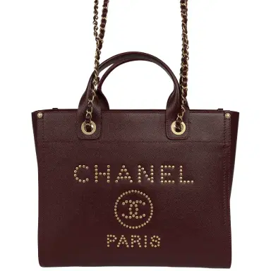 Chanel Chanel Small Studded Deauville Shopping Tote Burgundy Caviar Brushed Gold Hardware | Thumbnail 1 Chanel Chanel Small Studded Deauville Shopping Tote Burgundy Caviar Brushed Gold Hardware | Thumbnail 1