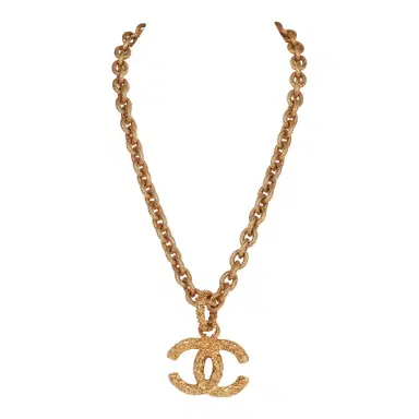 Chanel Vintage Chanel Gold Plated Lava CC Pendant Necklace | Thumbnail 1 Chanel Vintage Chanel Gold Plated Lava CC Pendant Necklace | Thumbnail 1