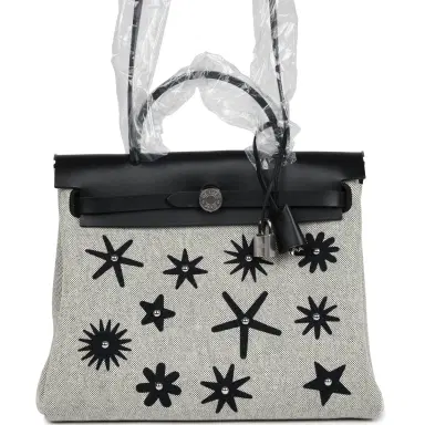 HERMÈS Hermes Herbag Zip 31 PM Hobnailed Black and Ecru Printed H Plume Canvas and Vache Hunter Palladium Hardware | Thumbnail 1 HERMÈS Hermes Herbag Zip 31 PM Hobnailed Black and Ecru Printed H Plume Canvas and Vache Hunter Palladium Hardware | Thumbnail 1