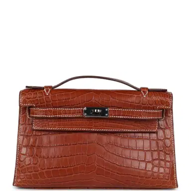 HERMÈS Pre-owned Hermes Kelly Pochette Fauve Matte Niloticus Crocodile Ruthenium Hardware | Thumbnail 1 HERMÈS Pre-owned Hermes Kelly Pochette Fauve Matte Niloticus Crocodile Ruthenium Hardware | Thumbnail 1
