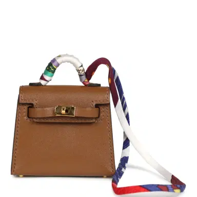 HERMÈS Hermes Mini Kelly Twilly Bag Charm Alezan Tadelakt Gold Hardware | Thumbnail 1 HERMÈS Hermes Mini Kelly Twilly Bag Charm Alezan Tadelakt Gold Hardware | Thumbnail 1
