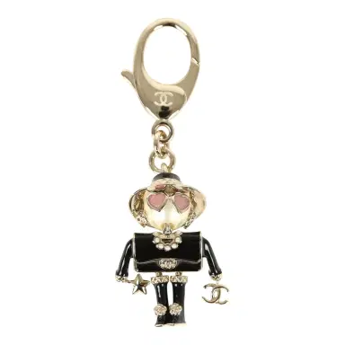 Chanel Chanel Gabrielle Doll Key Ring Black Resin & Faux Pearls Light Gold Tone Hardware | Thumbnail 1 Chanel Chanel Gabrielle Doll Key Ring Black Resin & Faux Pearls Light Gold Tone Hardware | Thumbnail 1