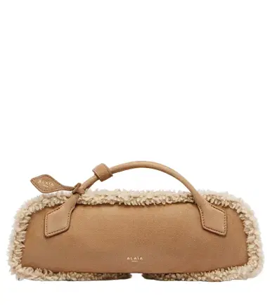 Alaïa Alaïa Le Teckel Small suede clutch | Thumbnail 1 Alaïa Alaïa Le Teckel Small suede clutch | Thumbnail 1