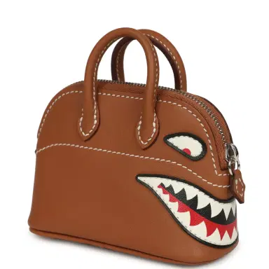 HERMÈS Hermes Mini Bolide Shark Bag Charm Gold and White Swift Palladium Hardware | Thumbnail 2 HERMÈS Hermes Mini Bolide Shark Bag Charm Gold and White Swift Palladium Hardware | Thumbnail 2