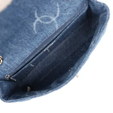 Chanel Pre-owned Chanel Medium Classic "CC Printed" Flap Bag Blue Denim Silver Hardware | Thumbnail 10 Chanel Pre-owned Chanel Medium Classic "CC Printed" Flap Bag Blue Denim Silver Hardware | Thumbnail 10
