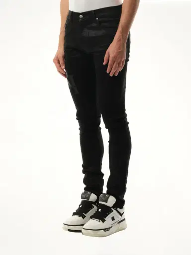 AMIRI Waxed Staggered Logo Skinny Jeans in Black Wax | Thumbnail 2 AMIRI Waxed Staggered Logo Skinny Jeans in Black Wax | Thumbnail 2