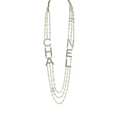 Chanel Chanel Long Crystal CHA-NEL Multi-Strand CC Pearl Necklace Ivory Pearls, Light Gold Tone Hardware | Thumbnail 1 Chanel Chanel Long Crystal CHA-NEL Multi-Strand CC Pearl Necklace Ivory Pearls, Light Gold Tone Hardware | Thumbnail 1